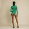 Green, fitted, long sleeve bodysuit has cutaway detail on front.