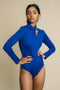 Blue, fitted, long sleeve bodysuit has cutaway detail on front. 