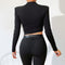 Slim, fit, long sleeve, black crop top has pad on shoulder. 