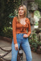 Rusty color, crop cardigan has full sleeve and adjustable tie front detail.