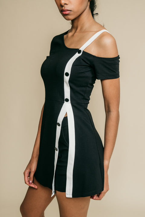 Two-piece mini black dress has short under the dress. Featuring white, one shoulder buttons design strap, goes from to the hem. 