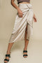 Beige, under knee skirt has front slit and stylish knot detail on waist.