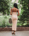 Nude color, figure hugging, long dress has thin adjustable sling and scoop neck. 