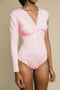 Light pink, one arm, long sleeve, ruched on chest bodysuit.