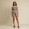 Brown, long sleeve, offshoulder bodysuit has contrasting draw detail on front.