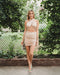 Plain nude color cross cut out dress has wrap neckline and one side of the skirt regulable drawstring. 