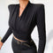 Slim, fit, long sleeve, black crop top has pad on shoulder. 